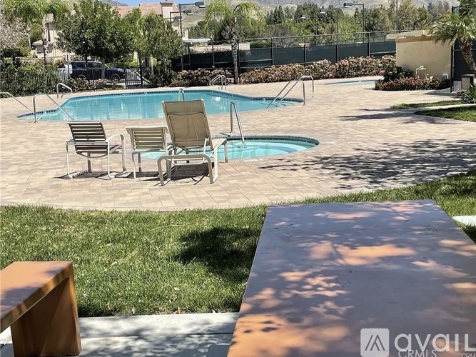 A pool with a chair and a table in front of it.