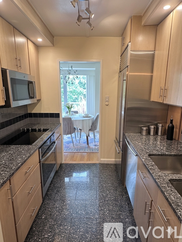 A kitchen with granite countertops and stainless steel appliances.