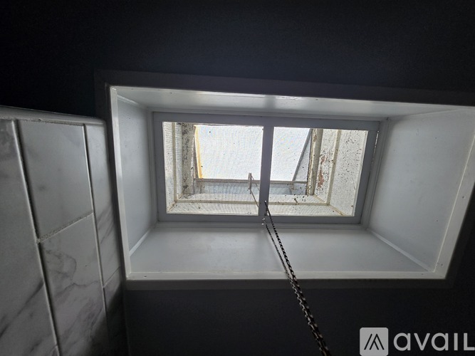 A window in a room with a view of a building outside.