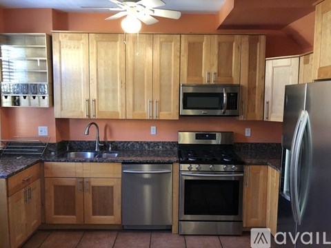 A kitchen with wooden cabinets and stainless steel appliances.