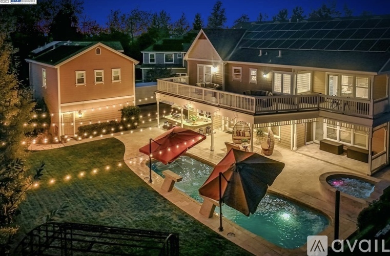 A house with a pool and patio area is available for rent.