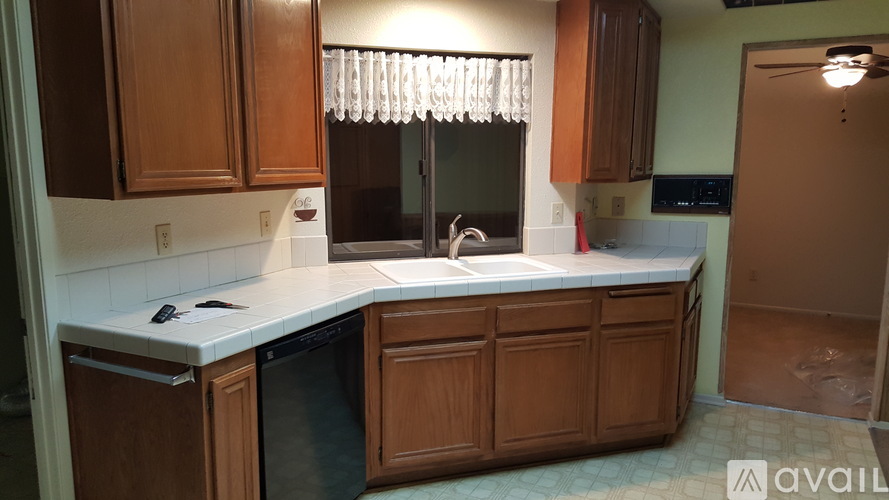A kitchen with wooden cabinets and a white countertop.