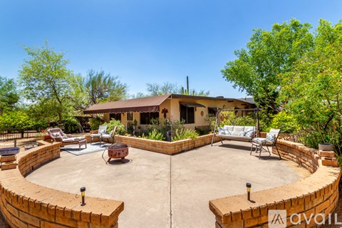 A house with a patio surrounded by a wall.