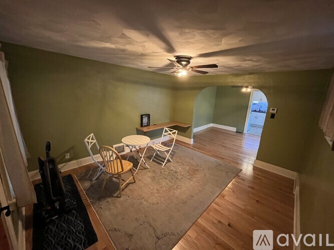 A room with a table and chairs in it.