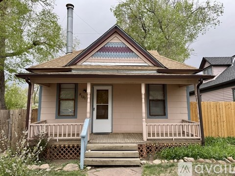 A small house with a porch and a front door.