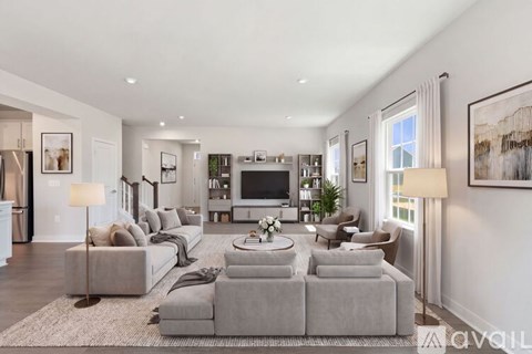 A living room with a grey sofa set and a television.