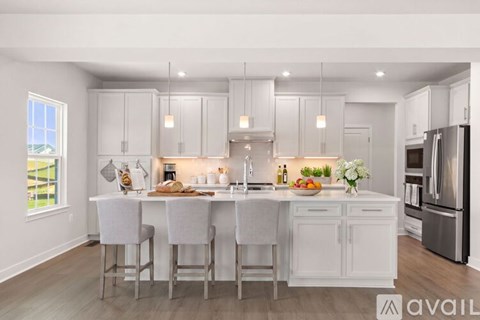 A modern kitchen with white cabinets and a center island.