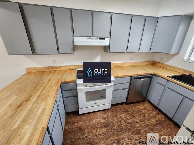 A kitchen with wooden countertops and a sign that says "ELITE Rentals".