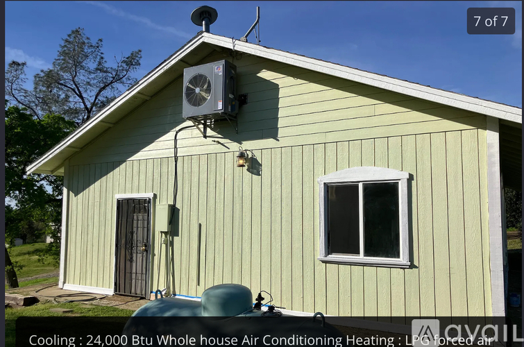 A house with a green siding and a white window.
