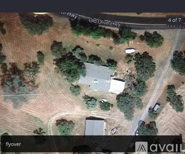 A satellite image shows a house surrounded by trees and a road labeled "Old Olive Hwy.".