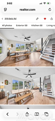 A real estate listing shows a spacious living room with a staircase.