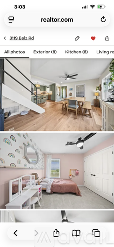 A bedroom with a bed and a ceiling fan.
