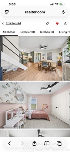 A bedroom with a bed and a ceiling fan.