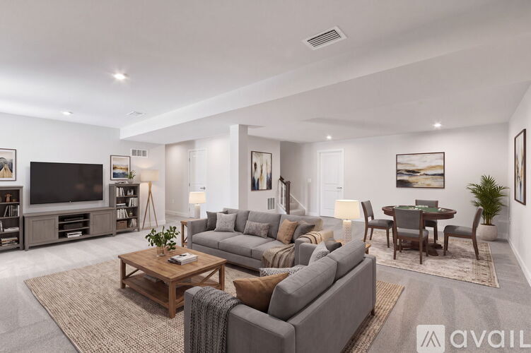 A modern living room with a grey sofa set and a wooden coffee table.