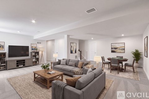 A modern living room with a grey sofa set and a wooden coffee table.