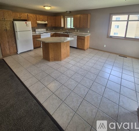 A kitchen with a white fridge and a white dishwasher.