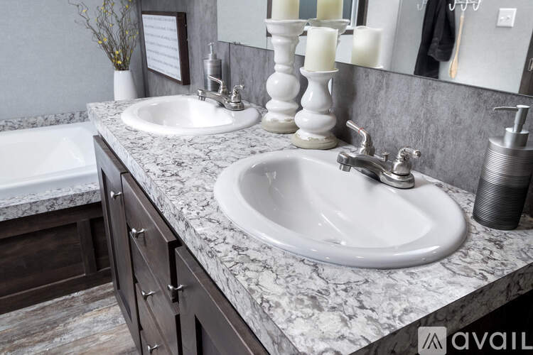 A bathroom with two sinks and a marble countertop.