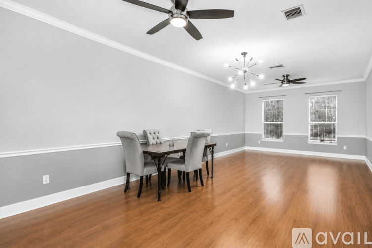 A dining room with a table and chairs.