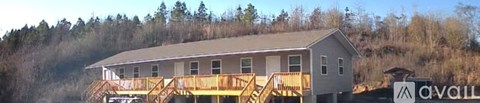 A house under construction with a brown wooden deck.