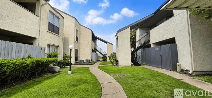A sunny day at the apartment complex with a clear blue sky.
