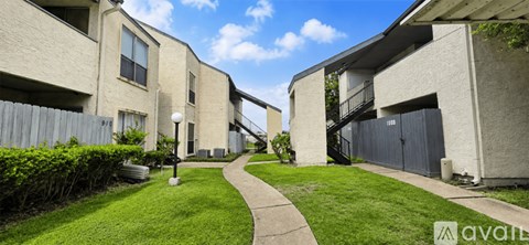 A sunny day at the apartment complex with a clear blue sky.