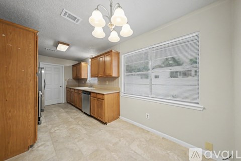 A kitchen with wooden cabinets and a white fridge.