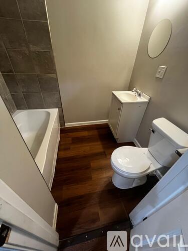 A bathroom with a toilet, sink, and bathtub.