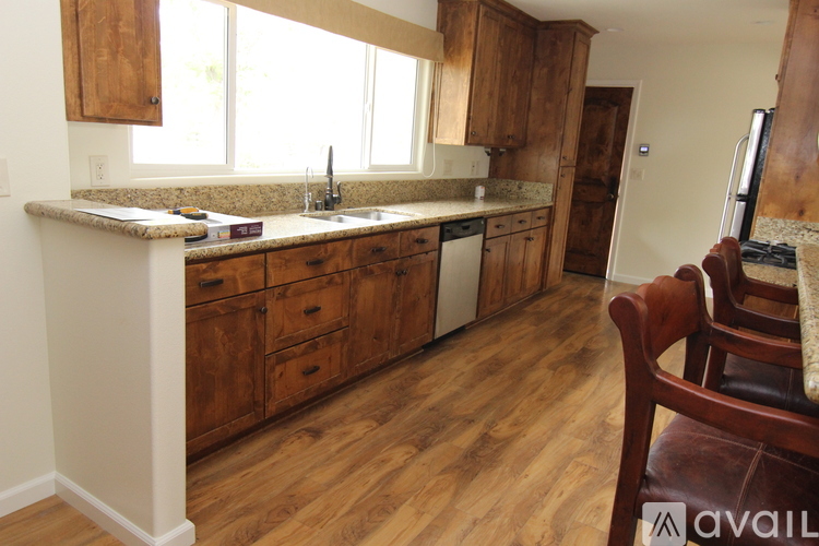 A kitchen with wooden cabinets and a counter top.