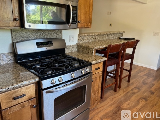 A kitchen with a stove, oven, and microwave.