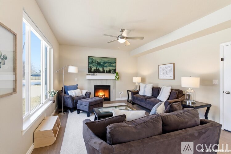 A living room with a fireplace and a painting on the wall.