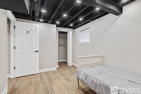 A bedroom with a bed, dresser, and closet.