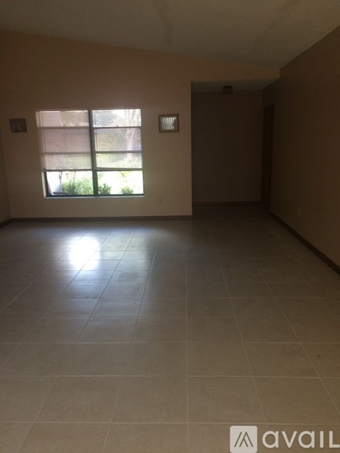 A room with beige walls and a tiled floor.