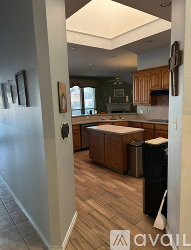 A kitchen with wooden cabinets and a white refrigerator.