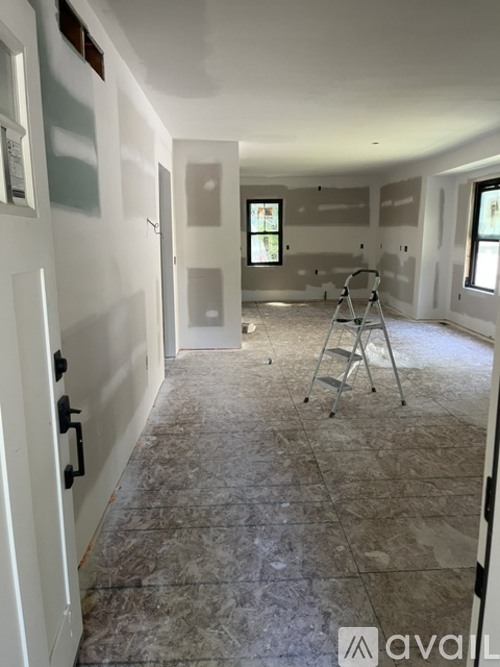 A room under construction with a ladder and no furniture.