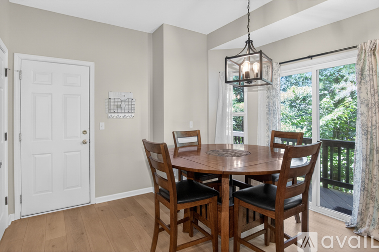 A dining room with a wooden table and chairs.