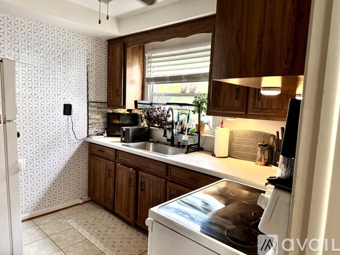 A kitchen with a white fridge and a washing machine.