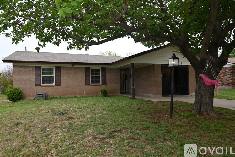 A house with a tree in front of it.