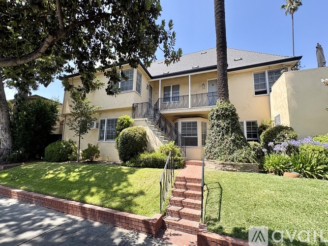 A two-story house with a balcony on the second floor.