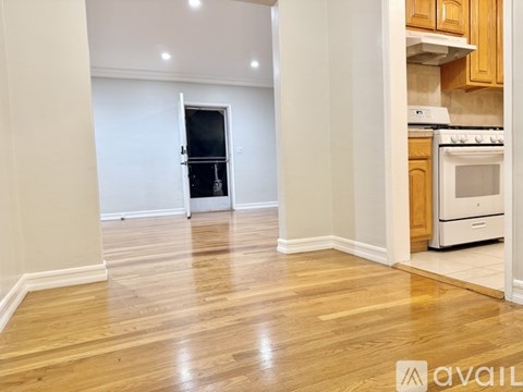 A kitchen with wooden cabinets and a white stove top oven.