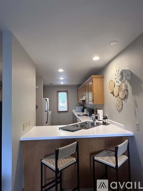 A kitchen with two chairs and a counter.