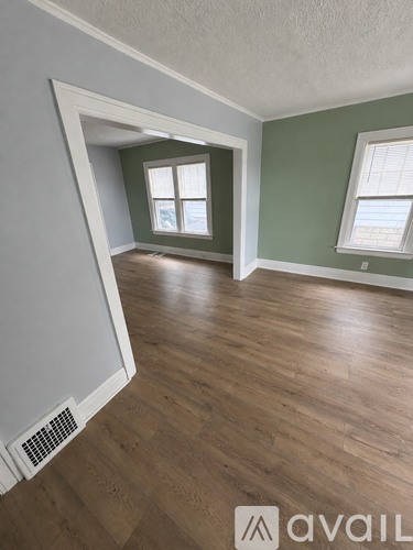 A room with wooden floors and a window.