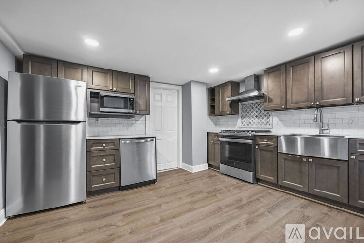 A modern kitchen with wooden cabinets and stainless steel appliances.