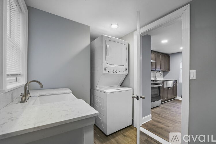 A bathroom with a white sink and a white cabinet.
