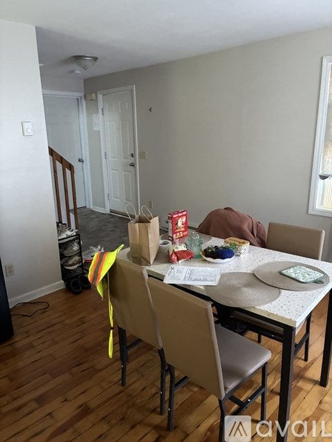 A dining room with a table set for four.
