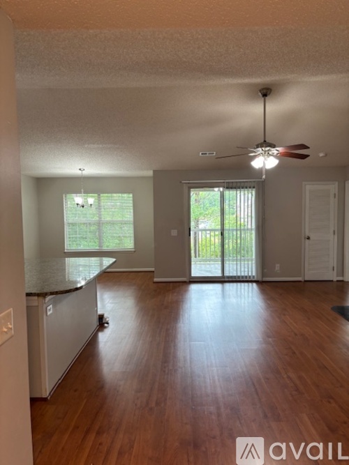 A room with wooden floors and a ceiling fan.