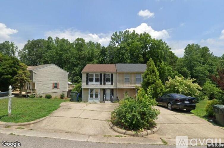 A house with a car parked in front of it.