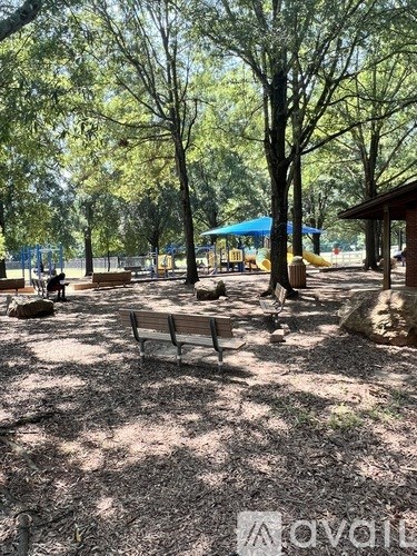 A park with a playground and benches.