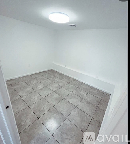 A room with a tiled floor and a ceiling light.