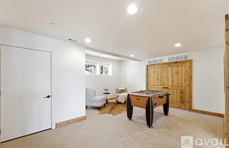 A room with a pool table and a couch.