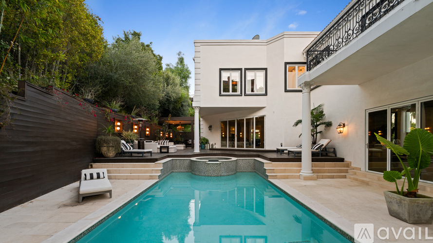 A modern house with a pool in the backyard.